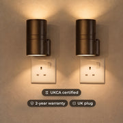 Plug-in up and down LED wall lights in black, glowing warm white